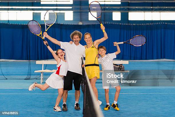 Cheerful Family Playing Indoor Tennis Stock Photo - Download Image Now - Daughter, Family, Father