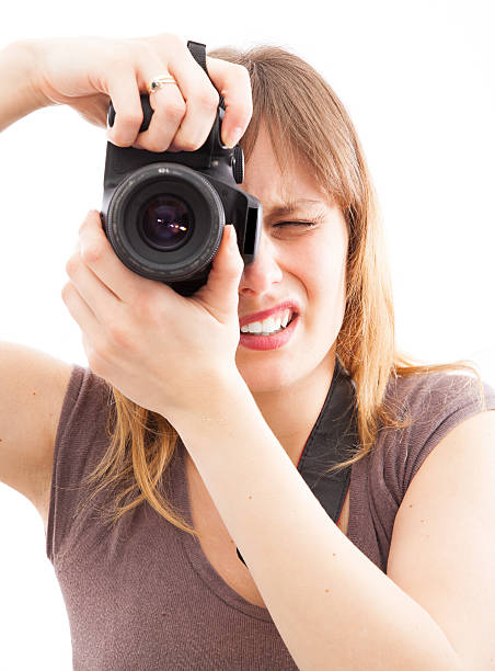 istock young woman using a camera to take photo 494619371