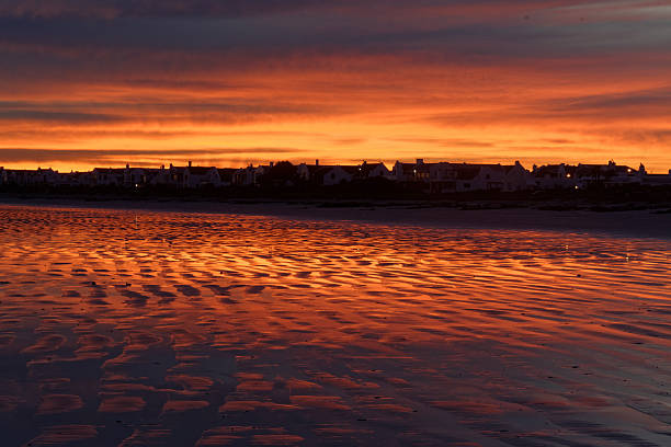 istock Red Sky at dawn reflected off the beach sand 494620187