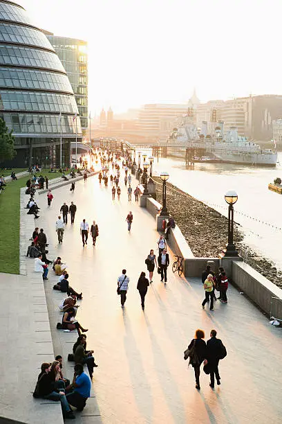 Tourists walking on the riverbank of Thames