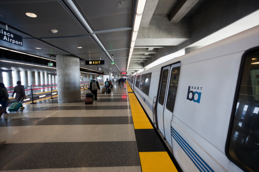 South San Francisco, California, United States - May 20, 2014: People disembarking from BART train at SFO station in South San Francisco.