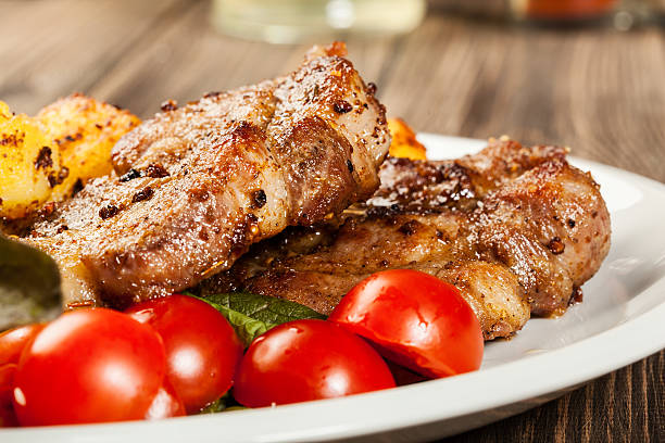 istock Grilled steaks, baked potatoes and vegetables 494624739