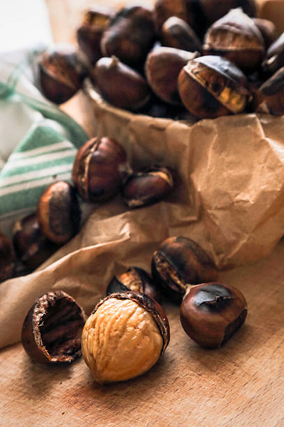 istock Fresh roasted chestnuts on wooden cutting board 494632788