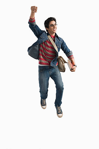 University student jumping in excitement stock photo