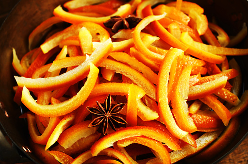 Cooking homemade sugared orange slices with spices, close up