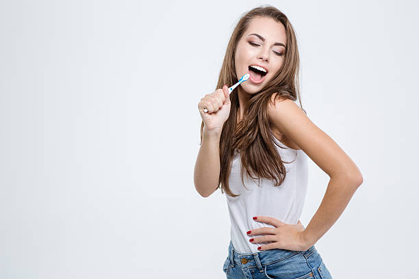 istock Woman cleaning her teeth with toothbrush 494634754