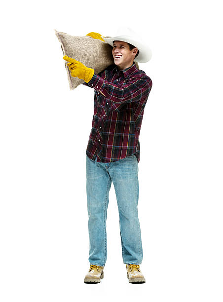 istock Cheerful farmer holding burlap sack and pointing 494635042
