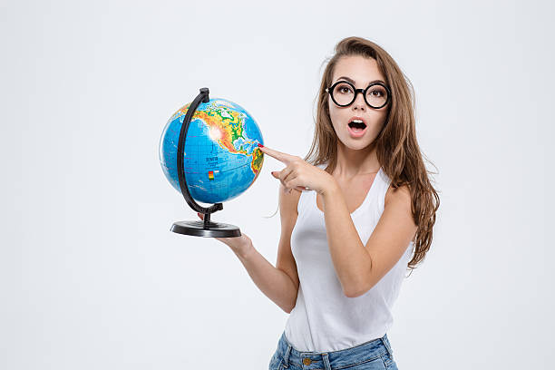 istock Beautiful young woman holding globe 494635094