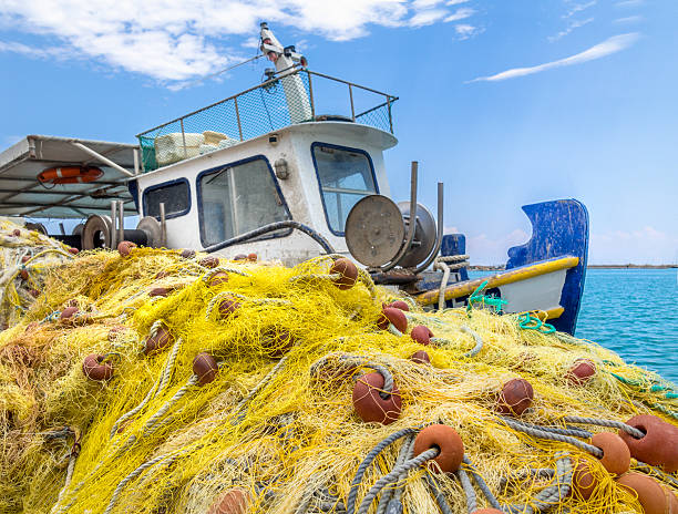Fishing trawler tied up to the dock, Fishing net with floats, ropes and weights in Zakynthos harbor