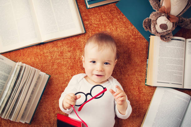 istock One year old baby with spectackles and a teddy bear 494635846