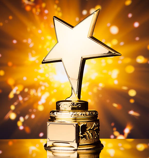istock gold star trophy against shiny sparks background 494638624