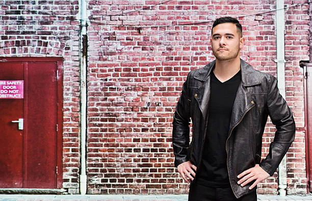 istock Casual man in front of birck wall 494641052