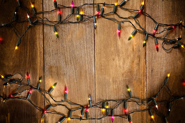Christmas and New Year lights on old wood background stock photo
