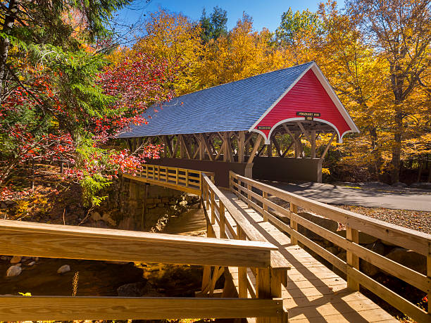 Covered bridge  Red covered bridge in Fanconia New Hampshire during Fall season grooved stock pictures, royalty-free photos & images