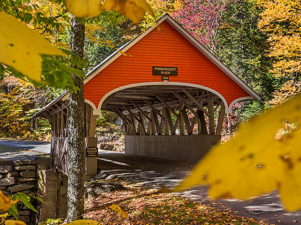 Covered bridge entrance  Red covered bridge in Fanconia, New Hampshire during Fall season franconia new hampshire stock pictures, royalty-free photos & images