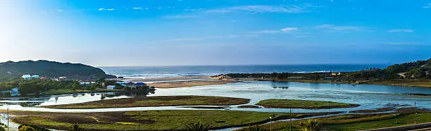 Lagoon at Mossel bay with the oil well seen in the distance at sea, towards the right. Mossel bay development took place after the discover of oil gas on the outskirts at sea.
