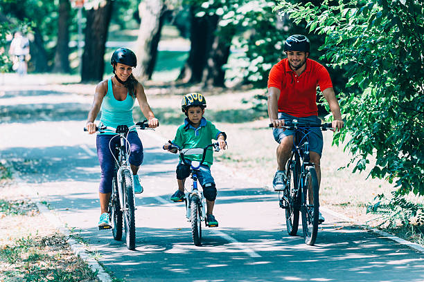istock Family of three riding bicycles 494662690