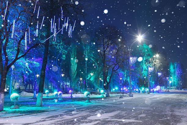 Christmas Night city. Christmas Night city. The city was decorated with beautiful lanterns hanging in the trees. Spotlights shine through the trees. Night. Mesmerizing light. Spotlights in the form of the planets in space. Copy space. Card. Winter background. moscow city stock pictures, royalty-free photos & images