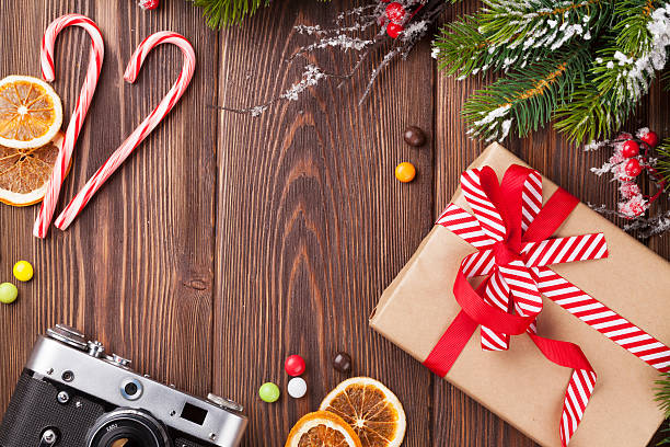 istock Christmas background with gift, camera and tree branch 494665266