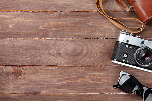 istock Camera and sunglasses on office desk 494666032