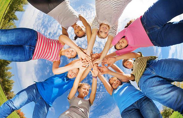 istock View from below of teens standing in star shape 494666314