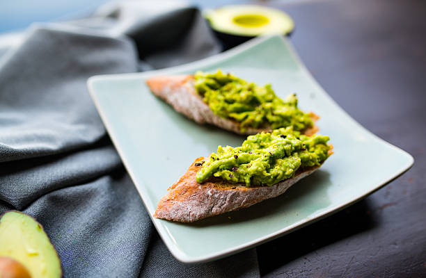 Healthy breakfast, vegetarian food, guacamole Healthy breakfast, vegetarian food, guacamole crostini stock pictures, royalty-free photos & images