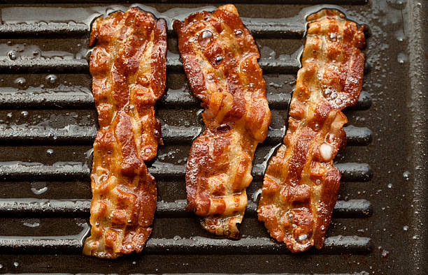 istock Sizzling Bacon Frying in a Pan 494667748