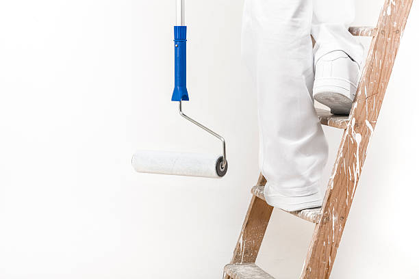 istock painter man at work climbing a ladder with pain 494670028