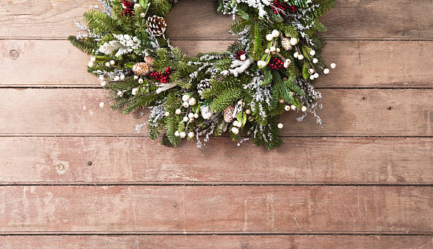 istock Christmas Wreath hung on barn board background. Copy space 494670642