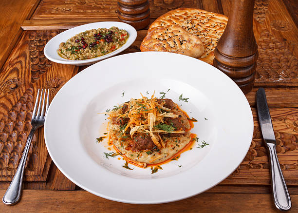 Sultan's Delight (Hunkar Begendi) Hunkar Begendi is lamb stew served on a bed of creamy roasted eggplant puree. hunkar begendi stock pictures, royalty-free photos & images