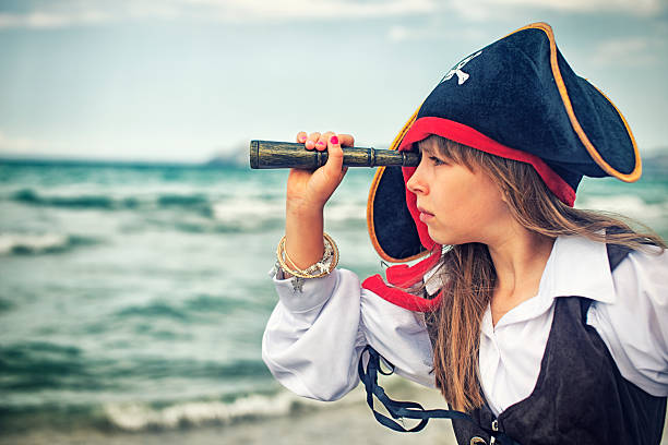 istock Pirate girl looking with spyglass 494674047