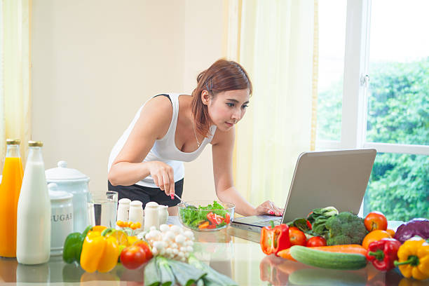 istock Young asian woman looking for a recipe 494674631