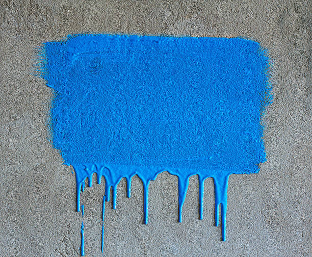 Brush strokes and paint drips on the concrete wall