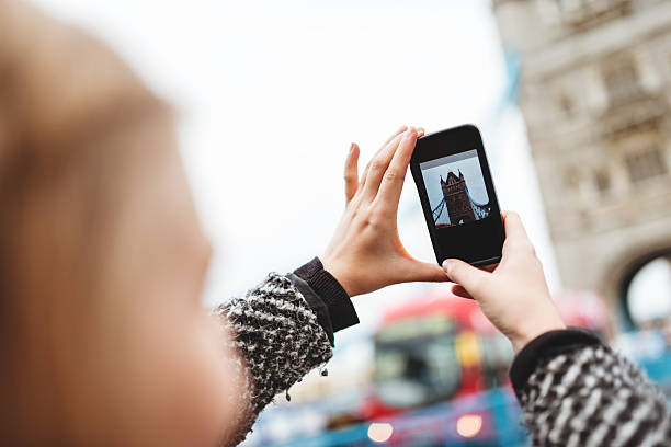 istock blonde british tourist photographing tower bridge 494676443