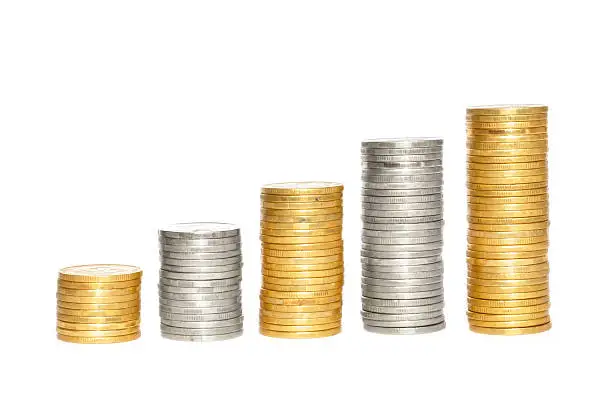 Savings, increasing columns of gold and silvercoins over white background