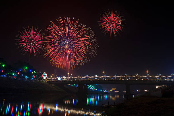 istock Fireworks over bridge and its reflections on Nan River ,Phitsanulok 494678359
