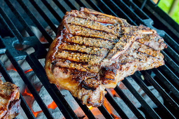 istock T-bone steak cooking on a grill on a summer day 494678529