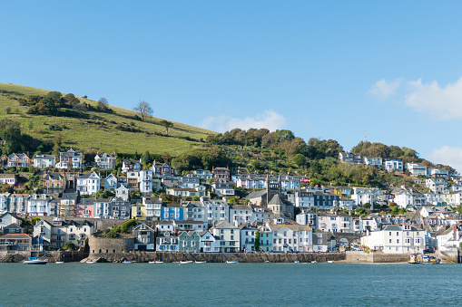 The popular travel destination and bustling port town of Dartmouth in Devon, UK.  Dartmouth is situated on the tidal Dart river.