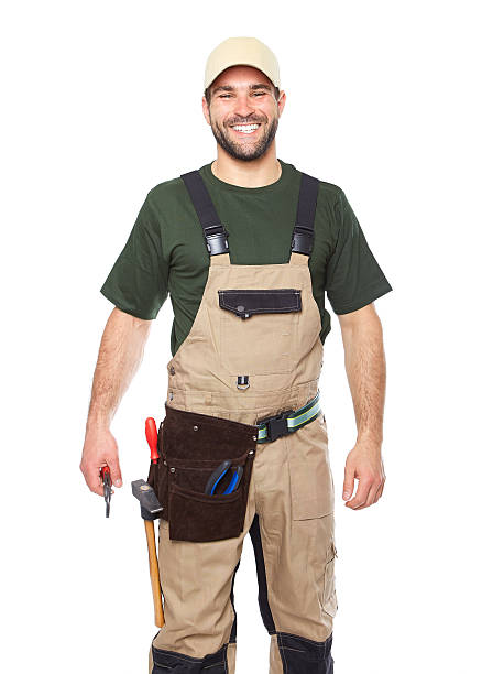 Portrait of smiling worker in brown uniform with tools