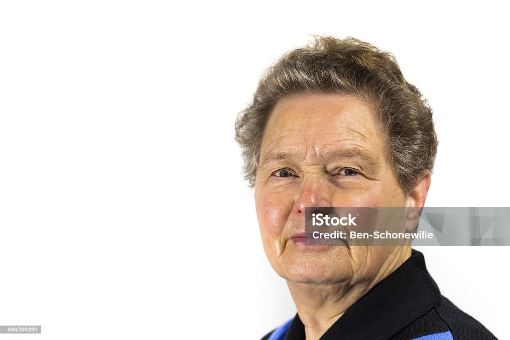 Portrait of a senior woman Close up of an older dutch woman isolated on white background. Portrait of senior caucasian woman looking at the camera. Only her head with face is visible. She smiles and looks happy. Concept of age,female,retired,feminine,happiness,person,people,cheerful,enjoy,european Active Seniors Stock Photo