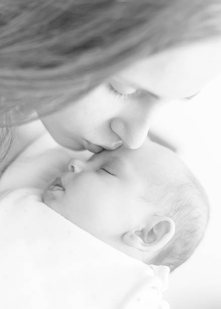 istock mother kissing her newborn 494709682