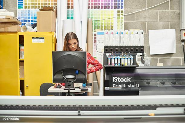 Young Woman Working At A Digital Printing Company Stock Photo - Download Image Now - Printing Press, Printing Plant, Printing Out