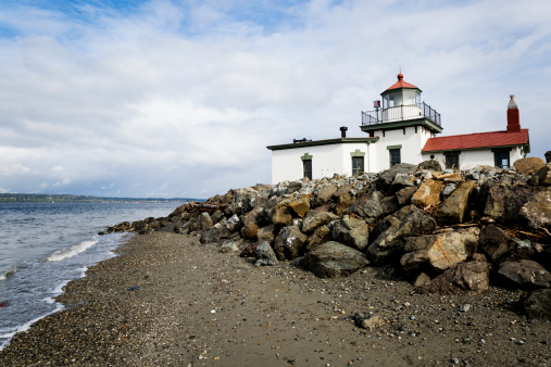 Angeled view of the West Point Lighthouse in Discovery Park, Seattle Washington.  The West Point Lighthouse is located on West Point, which juts out into Puget Sound.   This lighthouse began operating in the winter of 1881 and is still in use today.   It was manned until 1985 when it was automated.  