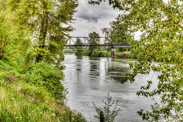 A High Dynamic Range photo of the Snohomish River in Snohomish Washington.  Old abandoned railroad trestle in the background.