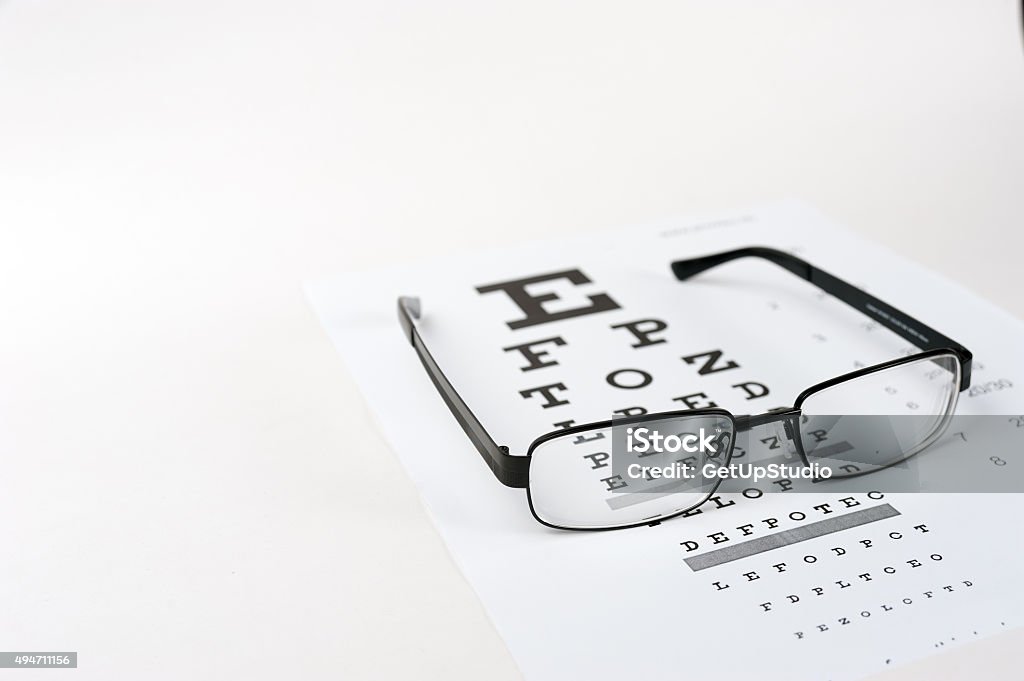 Eye glasses on eyesight test chart background close up Optometrist Stock Photo