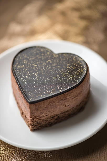 istock Heart Shaped Chocolate Cake on Gold Embroidered Tablecloth 494711203