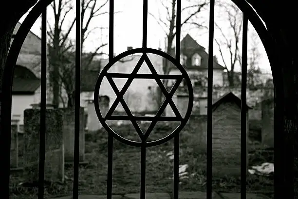 Judaism symbol. Jewish Star of David. Jude Cemetery in Cracow Ghetto. Kazimierz district. Poland. Auschwitz and Holocaust metaphor. Black and white.