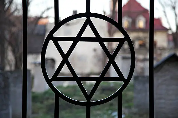 Judaism symbol. Jewish Star of David. Jude Cemetery in Cracow Ghetto. Kazimierz district. Poland. Auschwitz and Holocaust metaphor.