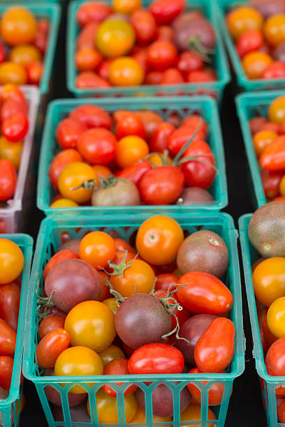 Assorted Color Tomatoes Multicolored home grown organic cherry tomatoes in display baskets grape tomato stock pictures, royalty-free photos & images