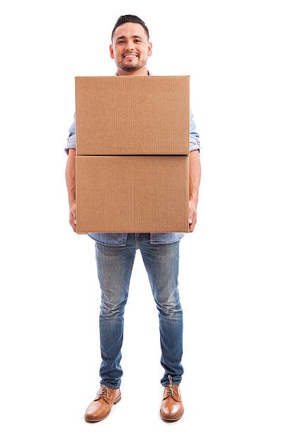 joven llevando cajas de algunas - box men holding isolated fotografías e imágenes de stock